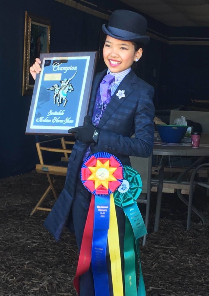 Sophie posing with her championship plaque after her class in Scottsdale